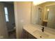 Bright bathroom with a white countertop, gray cabinets, and framed mirror at 4947 Amber Crest Dr, Brownsburg, IN 46112
