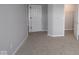 Carpeted bedroom showcasing a closet, door, and neutral walls at 4947 Amber Crest Dr, Brownsburg, IN 46112