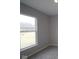 Neutral carpeted bedroom with a window overlooking a grassy lot at 4947 Amber Crest Dr, Brownsburg, IN 46112