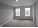 Bedroom with neutral carpet and windows overlooking adjacent homes at 4947 Amber Crest Dr, Brownsburg, IN 46112