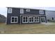 Back of the house with multiple windows and a sliding glass door, overlooking the yard at 4947 Amber Crest Dr, Brownsburg, IN 46112