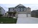 Charming home with stone accents, a large garage, and manicured lawn for curb appeal and outdoor enjoyment at 4947 Amber Crest Dr, Brownsburg, IN 46112