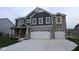 Beautiful two-story home with a stone and dark siding exterior and a spacious two-car garage at 4947 Amber Crest Dr, Brownsburg, IN 46112