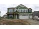 New two-story home featuring large windows and a two-car garage in an unfinished construction stage at 4947 Amber Crest Dr, Brownsburg, IN 46112