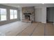 Open-concept living area with a stone fireplace and large windows, perfect for Gathering gatherings and entertaining at 4947 Amber Crest Dr, Brownsburg, IN 46112
