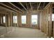 An unfinished living room featuring framing, visible studs, and multiple windows under construction at 4947 Amber Crest Dr, Brownsburg, IN 46112