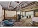 Unfinished basement area presents a blank canvas with exposed ceiling beams and concrete walls, ready for customization at 5035 Boulevard Pl, Indianapolis, IN 46208