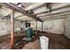 Unfinished basement area with exposed brick, beams, and concrete, offers flexibility for storage or future renovation projects at 5035 Boulevard Pl, Indianapolis, IN 46208