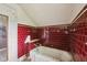 Bathroom interior with red tile walls and a worn bathtub at 5035 Boulevard Pl, Indianapolis, IN 46208