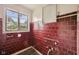 Bathroom interior with red tile walls and a window at 5035 Boulevard Pl, Indianapolis, IN 46208