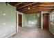 A bedroom interior featuring unfinished walls, wood floors, and exposed beams at 5035 Boulevard Pl, Indianapolis, IN 46208