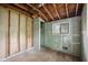 Bedroom with exposed wall studs, a window, closet and damage from renovation at 5035 Boulevard Pl, Indianapolis, IN 46208