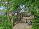 Charming exterior showcasing the house's design with its lush surroundings and interesting architectural elements at 5035 Boulevard Pl, Indianapolis, IN 46208