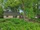 View showcasing the property's exterior features with mature trees and landscaping at 5035 Boulevard Pl, Indianapolis, IN 46208