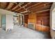 This fixer-upper living room has potential with a fireplace, built-ins, and view into what could be a new kitchen at 5035 Boulevard Pl, Indianapolis, IN 46208