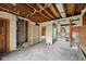 Fixer-upper living room showcases potential with an adjacent room and closet, ready for transformation at 5035 Boulevard Pl, Indianapolis, IN 46208