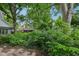 Exterior view of a lush yard with mature trees and green foliage at 5035 Boulevard Pl, Indianapolis, IN 46208