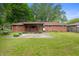 A red brick home with a covered back porch, a patio, and a large grass yard at 5092 S 50 W, Anderson, IN 46013