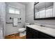 Bathroom featuring a black cabinet, mirror, toilet, towel bar, and window at 5092 S 50 W, Anderson, IN 46013
