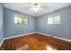 Bright bedroom with hardwood floors, neutral paint, and natural light from two windows at 5092 S 50 W, Anderson, IN 46013