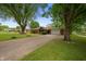 Street view of a brick ranch-style house with a long driveway and an attached garage at 5092 S 50 W, Anderson, IN 46013