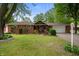 Charming red brick ranch-style home with manicured lawn and attached garage at 5092 S 50 W, Anderson, IN 46013