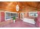 Inviting front porch with red brick, wooden ceiling, swing and ambient lighting at 5092 S 50 W, Anderson, IN 46013