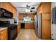Traditional kitchen featuring wooden cabinetry, black appliances, and tiled backsplash at 5092 S 50 W, Anderson, IN 46013