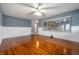 Sunlit living room featuring gleaming hardwood floors, panel moulding, and a large window at 5092 S 50 W, Anderson, IN 46013