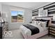 Chic bedroom featuring unique accent wall, stylish decor, and a bright window view at 5925 Sterling Dr, Whitestown, IN 46075