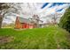 Large backyard featuring a detached garage, a chain-link fence, and ample green space at 5939 Olivia Dr, Alexandria, IN 46001
