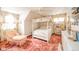 Charming bedroom with a four-poster bed, floral curtains, ceiling fan, and soft lighting at 5939 Olivia Dr, Alexandria, IN 46001
