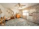 Cozy bedroom featuring an armchair, wooden dresser, carpet, and a ceiling fan at 5939 Olivia Dr, Alexandria, IN 46001