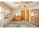 Comfortable bedroom featuring floral curtains, ceiling fan, wooden dresser, and carpet at 5939 Olivia Dr, Alexandria, IN 46001