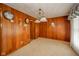 Traditional dining room featuring wood paneling, carpet, and a decorative chandelier at 5939 Olivia Dr, Alexandria, IN 46001