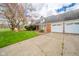 Traditional brick home showcasing a spacious driveway, established landscaping, and an attached two-car garage at 5939 Olivia Dr, Alexandria, IN 46001
