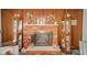 Close-up of a brick fireplace with a mantel, flanked by decorative display cases, adding character to the room at 5939 Olivia Dr, Alexandria, IN 46001