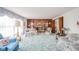 Spacious living room featuring a brick fireplace, wood paneling, and classic furnishings at 5939 Olivia Dr, Alexandria, IN 46001