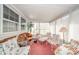 Bright sunroom with ample seating, large windows, and cozy decor at 5939 Olivia Dr, Alexandria, IN 46001