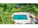 Aerial view of backyard pool with shed, patio, furniture, and landscaping at 5953 Deer Hollow Ct, Pittsboro, IN 46167