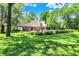 Spacious backyard with lush lawn, in-ground pool, and ample seating at 5953 Deer Hollow Ct, Pittsboro, IN 46167