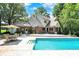 Beautiful backyard with a sparkling pool, patio furniture, and lush landscaping at 5953 Deer Hollow Ct, Pittsboro, IN 46167
