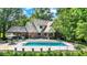 Serene backyard featuring a swimming pool, patio with furniture, and lush greenery at 5953 Deer Hollow Ct, Pittsboro, IN 46167