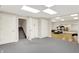 Spacious finished basement with gray carpet flooring and an adjacent exercise area at 5953 Deer Hollow Ct, Pittsboro, IN 46167