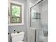 Modern bathroom with a glass-enclosed shower, toilet, and window providing natural light at 5953 Deer Hollow Ct, Pittsboro, IN 46167