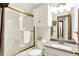 Bright bathroom featuring a tub shower combo, vanity, and white color palette at 5953 Deer Hollow Ct, Pittsboro, IN 46167