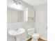 Clean, classic bathroom with pedestal sink, toilet, and mirrored cabinet at 5953 Deer Hollow Ct, Pittsboro, IN 46167