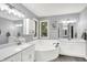 Spacious bathroom featuring a large soaking tub, double vanity, and neutral color palette at 5953 Deer Hollow Ct, Pittsboro, IN 46167