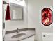 Stylish bathroom featuring a modern sink, granite countertop, and unique decorative mirror at 5953 Deer Hollow Ct, Pittsboro, IN 46167