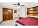 Comfortable bedroom with a wooden chest, built-in shelving, and double closets at 5953 Deer Hollow Ct, Pittsboro, IN 46167